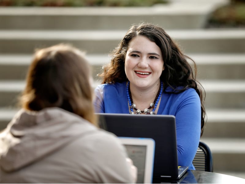 University of Kentucky students studying at a table outdoors