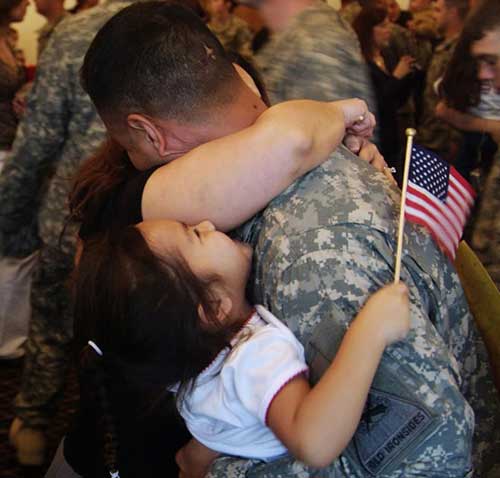 Military man holding child